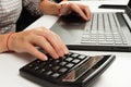 Female hands are typing text on laptop keyboard on white table background Royalty Free Stock Photo