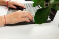 Female hands are typing text on laptop keyboard on white table background Royalty Free Stock Photo