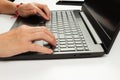 Female hands are typing text on laptop keyboard on white table background Royalty Free Stock Photo