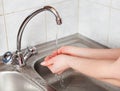 Female hands under the running water Royalty Free Stock Photo