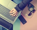 Female hands use a laptop on the background of a bag, smartphone Royalty Free Stock Photo