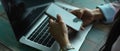 Female hands using smartphone while working with laptop in office room Royalty Free Stock Photo