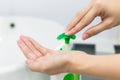 Female hands using wash hand sanitizer gel pump dispenser. Royalty Free Stock Photo