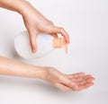 Female hands using wash hand sanitizer gel pump dispenser Royalty Free Stock Photo