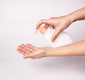 Female hands using wash hand sanitizer gel pump dispenser Royalty Free Stock Photo