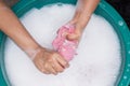 Female hands wash clothing by hand with detergent in basin. selective focus and space for text