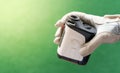 Female hands wearing professional glove with white and black modern optical range finder used for golfing or hunting Royalty Free Stock Photo