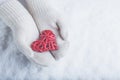 Female Hands In White Knitted Mittens With Entwined Vintage Romantic Red Heart On Snow Background. Love And St. Valentine Concept