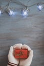 Female Hands In White Knitted Mittens With Entwined Vintage Romantic gift box On blue Background Royalty Free Stock Photo