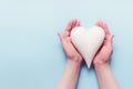 Female hands with white porcelein heart