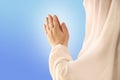 Female hands, women in a white cloak raised palms with a prayer to God, the concept of prayers, sins, remorse, guilt, requests