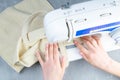 Female hands work on a sewing machine, sewing coffee towel. Close-up Royalty Free Stock Photo