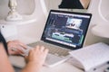 Female hands working on a laptop in a video editing program Royalty Free Stock Photo