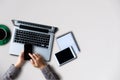 Female hands working on modern laptop. Office desktop on white background. Royalty Free Stock Photo