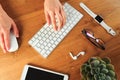 Female hands working with modern white keyboard and mouse on wooden background, top view  - Image Royalty Free Stock Photo