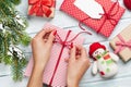 Female hands wrapping christmas gift