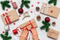Female hands wrapping Christmas present. Festive holiday preparation with woman hands, gift boxes, baubles, decoration Royalty Free Stock Photo