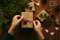 Female hands while wrapping Christmas present Royalty Free Stock Photo