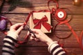 Female hands wrapping a gift