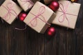 Christmas gifts box presents with red balls on wooden background Royalty Free Stock Photo