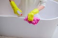 Female hands with yellow rubber gloves cleaning bath Royalty Free Stock Photo