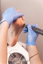 Female hardware pedicure in the salon. Professional hardware pedicure using electric machine. Patient on medical Royalty Free Stock Photo