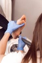 Female hardware pedicure in the salon. Professional hardware pedicure using electric machine. Patient on medical Royalty Free Stock Photo