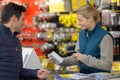 Female hardware store seller scanning clients item