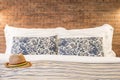 Female hat and pillow on the bed of a hotel room Royalty Free Stock Photo