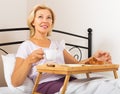 Female having breakfast in bed Royalty Free Stock Photo