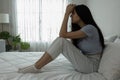 Female having depression sitting alone in bedroom corner. woman headache unhappy emotion. young anxiety despairing mental health