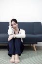 Female having depression sitting alone on sofa. woman headache unhappy emotion. young anxiety despairing mental health problems