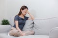 Female having depression sitting alone on sofa. woman her face covered with headache. unhappy emotion