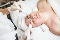 Female having hydradermie facial treatment in in beauty clinic