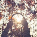 Female with headphones walking on the park listen sounds or music of autumn forest. Concept. Indian summer