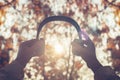 Female with headphones walking on the park listen sounds or music of autumn forest. Concept. Indian summer