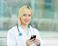Female health care professional, doctor holding smart phone Royalty Free Stock Photo