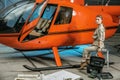 Beautiful female helicopter mechanic at work. feminism