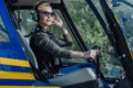 Female helicopter pilot posing at steering wheel