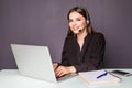 Female helpline operator with headphones and laptop in office Royalty Free Stock Photo