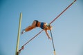 Female high jumper training at the stadium in sunny day