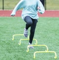 Front view of running over yellow mini hurdles Royalty Free Stock Photo