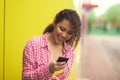 Female High School Student By Lockers Using Mobile Phone Royalty Free Stock Photo