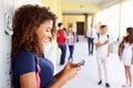 Female High School Student By Lockers Using Mobile Phone Royalty Free Stock Photo