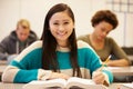 Female High School Student Studying At Desk In Classroom Royalty Free Stock Photo