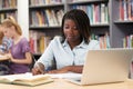 Female High School Student Working At Laptop In Library Royalty Free Stock Photo