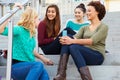 Female High School Students Sitting Outside Building Royalty Free Stock Photo