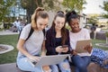 Female High School Students Using Digital Devices Outdoors During Recess