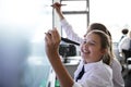 Female High School Students Wearing Uniform Using Interactive Whiteboard During Lesson Royalty Free Stock Photo