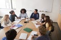 Female High School Tutor Sitting At Table With Pupils Teaching Maths Class Royalty Free Stock Photo